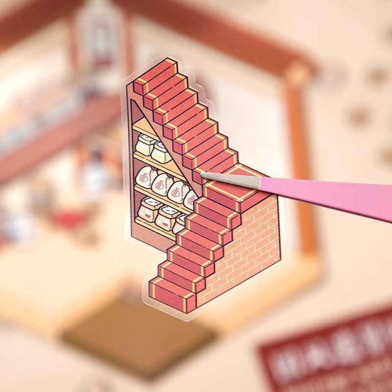 Isometric scene sticker of brick staircase with shelves, held by pink tweezers for DIY tiny world decor
