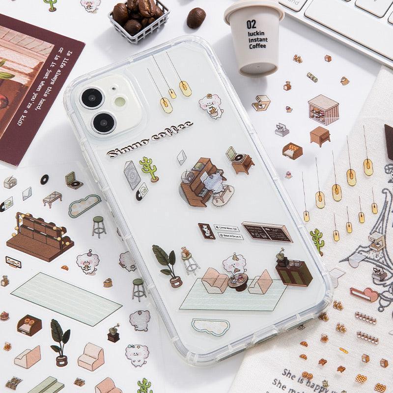 Cozy coffee shop scene sticker set on phone case, featuring isometric furniture, plants, and decor for DIY tiny worlds.